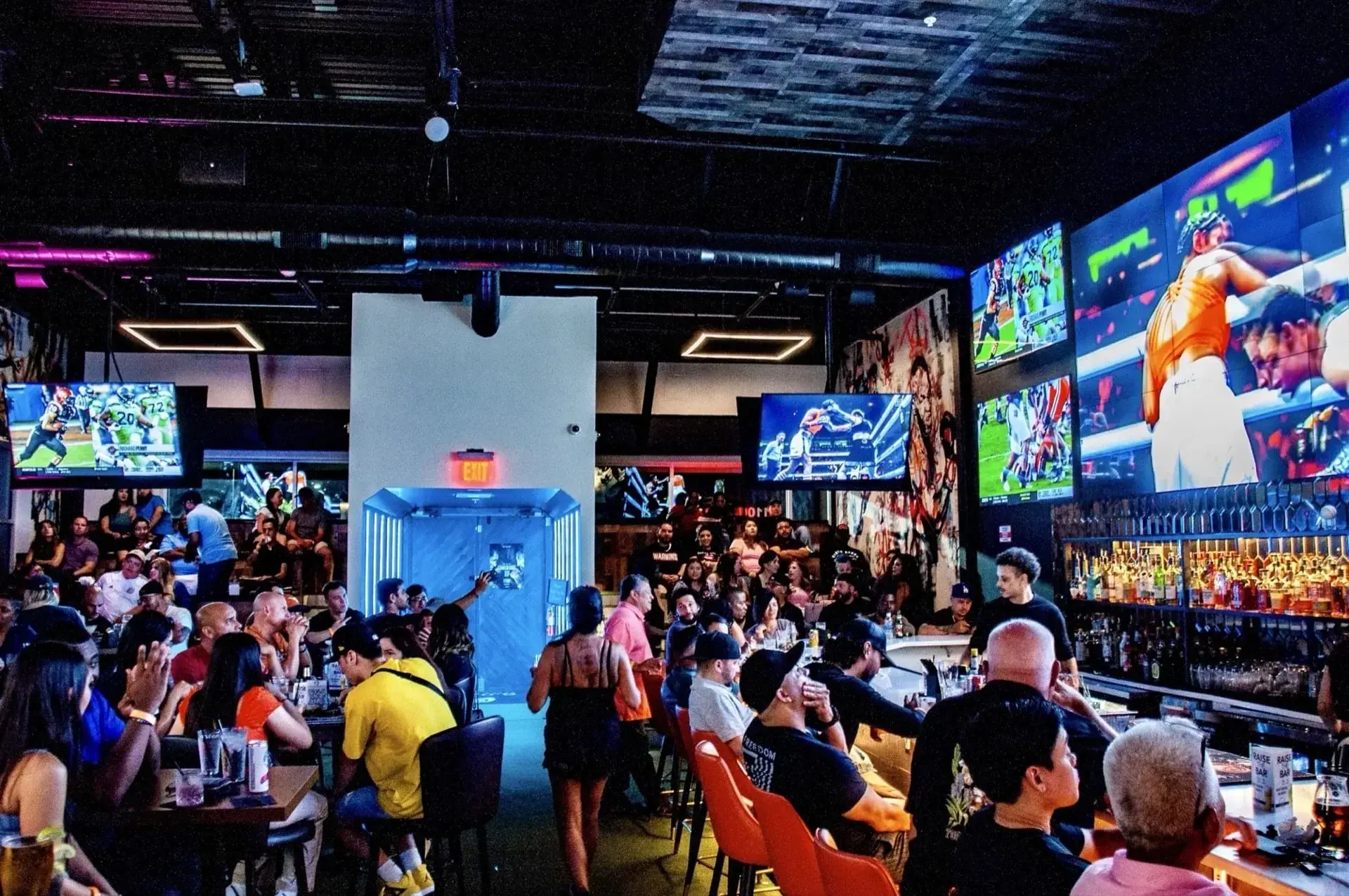Crowd enjoying game day at G.O.A.T's Arena sports bar in North Texas